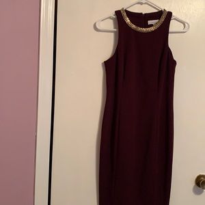Burgundy sheath dress with gold choker collar by Calvin Klein